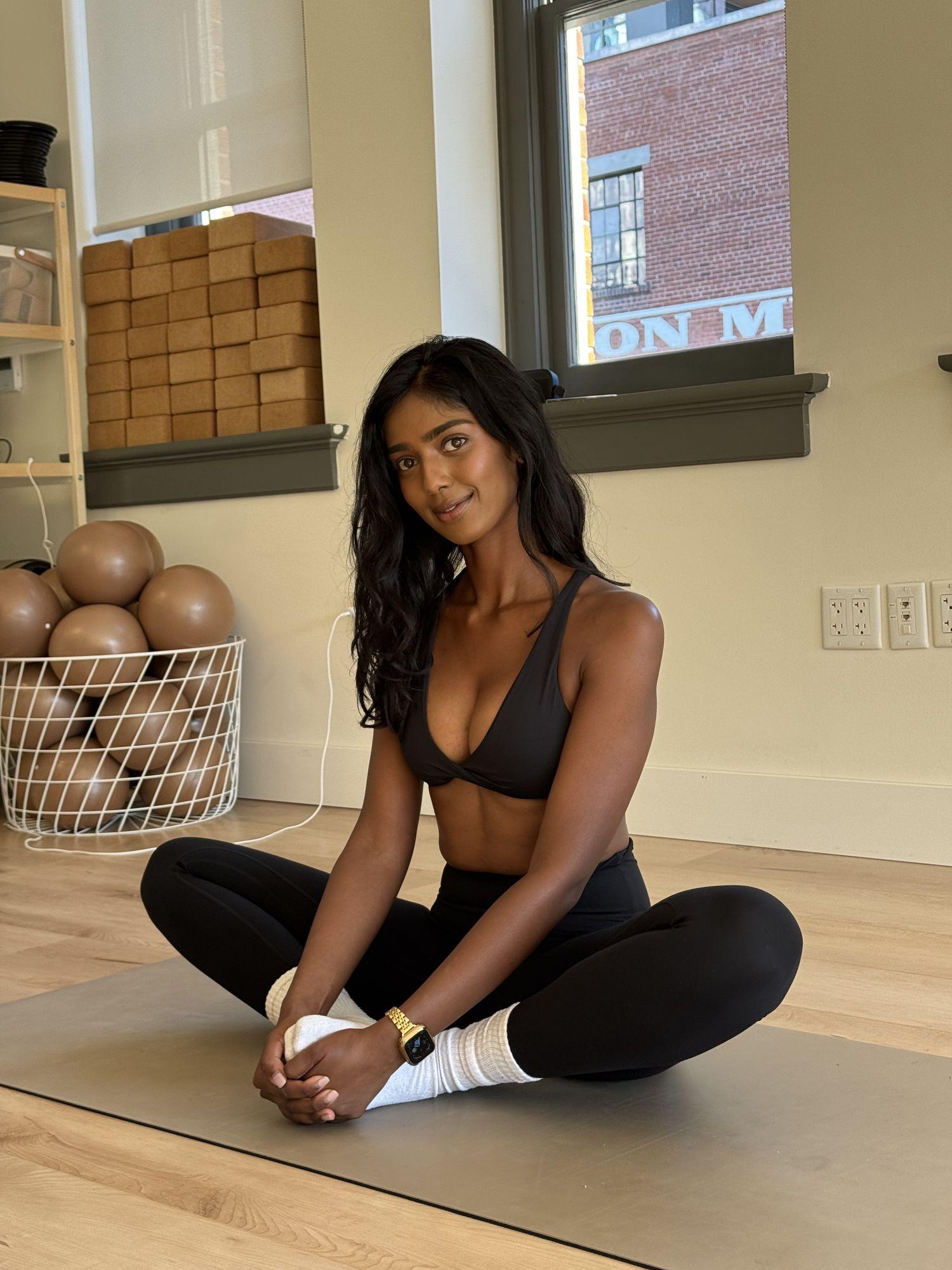 Woman seated on a mat in a calm studio