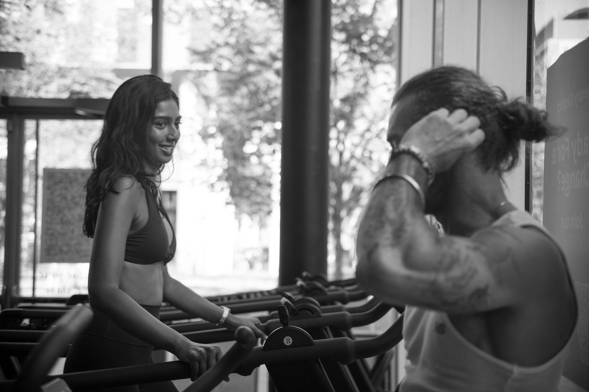 Client and trainer between sets on the studio bikes